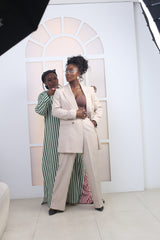 Madame Modish adjusts Folu Storms’ look on set for the L’Élégance en Parade fashion film.